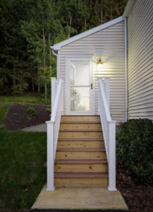 wooden stairs leading to door						